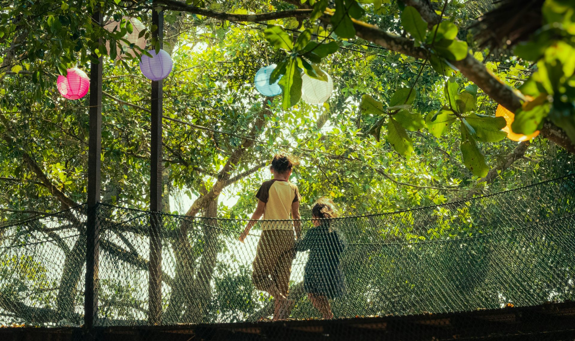 A woman and a child walking across a bridge
